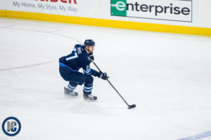 Tyler Myers with the puck