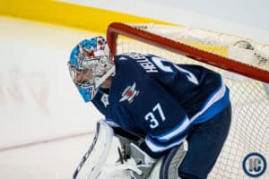 Connor Hellebuyck in his net